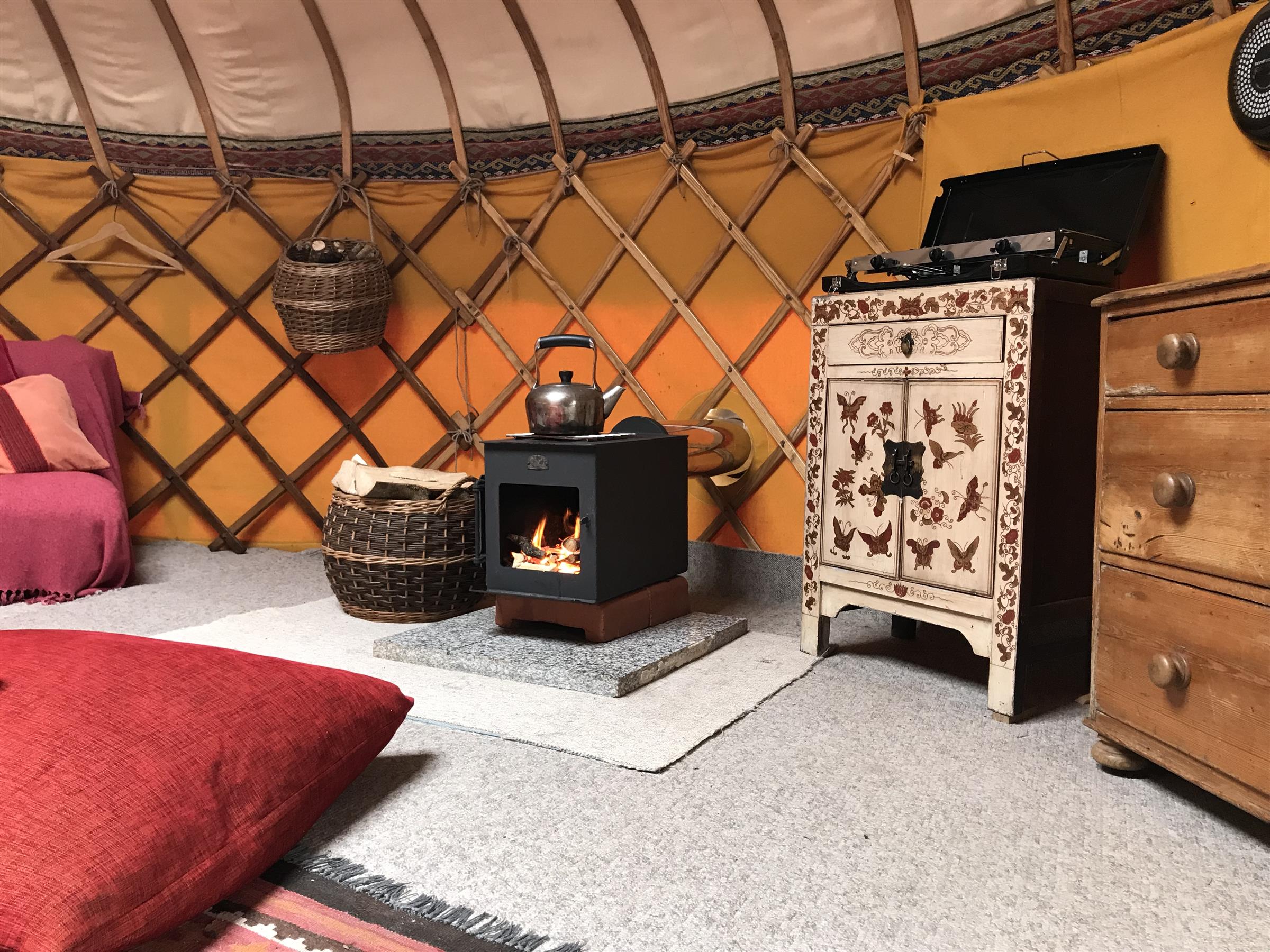 Interior of Ash Field Yurt with wood burner and gas cooker